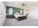 Bright main bedroom with a ceiling fan, neutral carpet, and large windows for abundant natural light at 18809 W 92Nd Dr, Arvada, CO 80007