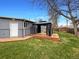 Fenced backyard with lawn, wood deck, and gazebo for outdoor living at 6757 Lee St, Arvada, CO 80004