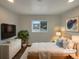 Bright bedroom with white and wood furniture, recessed lights and a window at 6757 Lee St, Arvada, CO 80004
