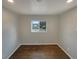 Bright bedroom with fresh paint, window and hardwood flooring at 6757 Lee St, Arvada, CO 80004