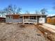 Charming ranch-style home featuring a gray exterior, ramp, and tidy landscaping at 6757 Lee St, Arvada, CO 80004