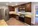 Updated kitchen featuring stainless steel appliances, granite countertops, and wood cabinetry at 6757 Lee St, Arvada, CO 80004