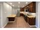 Modern kitchen with stainless steel appliances, granite counters, and dark cabinets at 6757 Lee St, Arvada, CO 80004