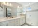 Luxurious bathroom with dual sinks, a frameless glass shower, and modern finishes, perfect for relaxation at 8948 Delacorte St, Highlands Ranch, CO 80129
