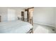 Comfortable bedroom with decorative iron bed frame and sliding barn door leading to the ensuite bathroom at 8948 Delacorte St, Highlands Ranch, CO 80129