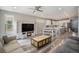 Open-concept living area with modern flooring, fireplace, and seamlessly connected kitchen at 8948 Delacorte St, Highlands Ranch, CO 80129