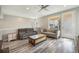 Comfortable living room features neutral tones, two sofas, unique coffee table, and ample natural light at 8948 Delacorte St, Littleton, CO 80129