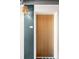 Apartment door with modern hardware, alongside a stylishly painted wall and a decorative hanging light at 603 Inca St # 432, Denver, CO 80204