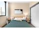Bright bedroom featuring a large window, closet, stylish furnishings, and sleek side tables at 603 Inca St # 432, Denver, CO 80204