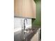 Well-organized laundry room with light wood cabinets, modern sink fixture, and white subway tile backsplash at 603 Inca St # 432, Denver, CO 80204