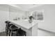 Basement wet bar with white cabinets and quartz countertops at 11064 W Hinsdale Dr, Littleton, CO 80127