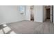 Bright bedroom with neutral carpet and white walls is naturally lit from a single window at 8644 Pennycress Dr, Littleton, CO 80125
