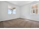 Bedroom with natural light, neutral carpet, and views of the outside at 8644 Pennycress Dr, Littleton, CO 80125