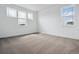 Bright bedroom with neutral carpet and white walls is naturally lit from three windows at 8644 Pennycress Dr, Littleton, CO 80125