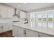 Modern kitchen with white cabinets, a large island, and stainless steel appliances at 8644 Pennycress Dr, Littleton, CO 80125