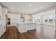 Gourmet kitchen featuring white cabinets, a center island, and an open layout at 8644 Pennycress Dr, Littleton, CO 80125