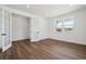 Bright, open-concept living room with hardwood floors, white walls, and large windows at 8644 Pennycress Dr, Littleton, CO 80125