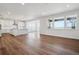 Open-concept living area featuring hardwood floors and natural lighting from large window at 8644 Pennycress Dr, Littleton, CO 80125