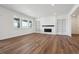 Bright living room with hardwood floors, built-in shelves, and a cozy fireplace at 8644 Pennycress Dr, Littleton, CO 80125