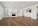 Bright living room featuring a modern fireplace, built-in bookshelves, and stylish hardwood floors at 8644 Pennycress Dr, Littleton, CO 80125