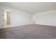 Spacious main bedroom with neutral carpet and en suite bathroom with a glass shower at 8644 Pennycress Dr, Littleton, CO 80125