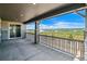 Covered patio with stone detailing, railing, and scenic views of the surrounding landscape at 8644 Pennycress Dr, Littleton, CO 80125
