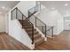 Modern staircase with black metal railings, leading to the upper level of the home at 8644 Pennycress Dr, Littleton, CO 80125