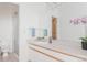 Bathroom featuring white cabinetry, a large mirror, and a glass enclosed shower at 79 Huron Ct, Boulder, CO 80303