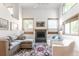Living room boasts vaulted ceilings, a cozy fireplace, and lots of natural light through large windows at 79 Huron Ct, Boulder, CO 80303