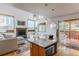 Open-concept living room boasts fireplace and flows into the kitchen with an island at 79 Huron Ct, Boulder, CO 80303