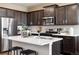 Modern kitchen featuring stainless steel appliances, a center island with seating, and stylish cabinetry at 1356 S Boston Ct # A, Denver, CO 80247