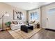Cozy living room with a large window, plush seating, and elegant neutral decor at 1356 S Boston Ct # A, Denver, CO 80247