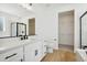 Bathroom featuring modern fixtures, a large mirror, vanity, and glass-enclosed shower at 42998 Colonial Trl, Elizabeth, CO 80107