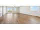 Spacious living room with hardwood floors, large windows, and a double door that lead to the yard at 42998 Colonial Trl, Elizabeth, CO 80107