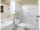 Clean bathroom with tub, toilet, vanity, and tiled walls and a glass door at 555 E 10Th Ave # 15, Denver, CO 80203