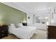 Relaxing bedroom with ample natural light and comfortable furnishings and a wall painted green at 555 E 10Th Ave # 15, Denver, CO 80203