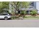 Inviting home exterior featuring well-maintained landscaping and a charming brick wall at 555 E 10Th Ave # 15, Denver, CO 80203
