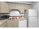 Efficient kitchen layout with appliances, neutral cabinets, and ample counter space at 555 E 10Th Ave # 15, Denver, CO 80203