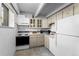 Functional kitchen featuring appliances, ample cabinet space, and tiled backsplash at 555 E 10Th Ave # 15, Denver, CO 80203