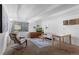 Cozy living room with beamed ceilings, neutral decor, and comfortable seating arrangement at 555 E 10Th Ave # 15, Denver, CO 80203