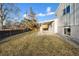 Grass backyard with covered patio and gravel at 6675 S Apache Dr, Littleton, CO 80120