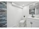 Updated bathroom with blue tile, white vanity, and modern fixtures at 6675 S Apache Dr, Littleton, CO 80120