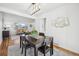 Bright dining area with hardwood floors, a dining table, and an open concept layout at 6675 S Apache Dr, Littleton, CO 80120