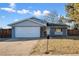 Newly painted house with a two-car garage at 6675 S Apache Dr, Littleton, CO 80120