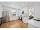 Modern kitchen with white cabinets, stainless steel appliances, and hardwood floors at 6675 S Apache Dr, Littleton, CO 80120