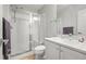 Well-lit bathroom featuring glass shower doors, sink, and cabinet at 10256 Olathe Way, Commerce City, CO 80022