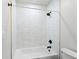 Bright bathroom featuring subway tile surround, matte black fixtures, and a clean, white tub at 1308 Stuart St, Denver, CO 80204