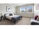 Bright bedroom featuring a bed, windows with blinds, and neutral decor at 1308 Stuart St, Denver, CO 80204