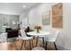 Stylish dining area with modern table and chairs, complemented by trendy artwork and living room view at 1308 Stuart St, Denver, CO 80204