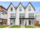 Modern townhouse exterior showcasing a clean, white facade with black trim and inviting front entrances at 1308 Stuart St, Denver, CO 80204